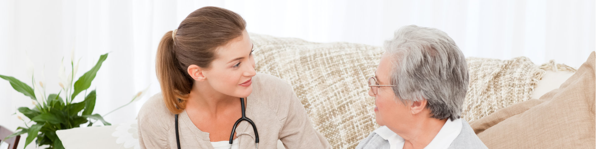 Nurse talking with her patient at home